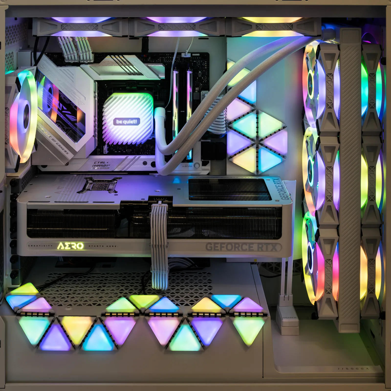 Interior of a PC build showing motherboard, RGB RAM, graphics card and components