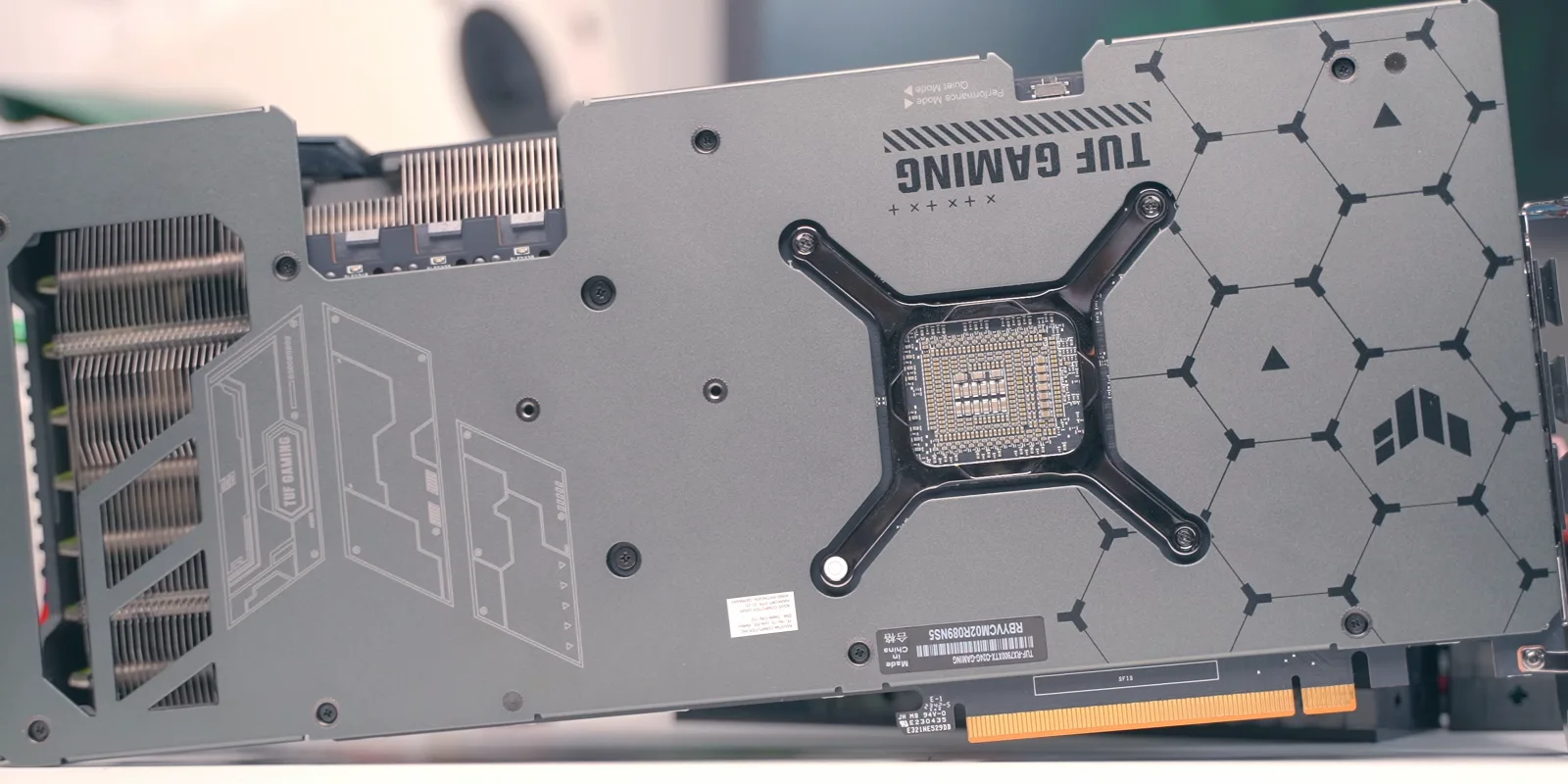 Modern triple-fan gaming graphics card (ASUS TUF Gaming Radeon RX 7900 XTX) on a dark backdrop