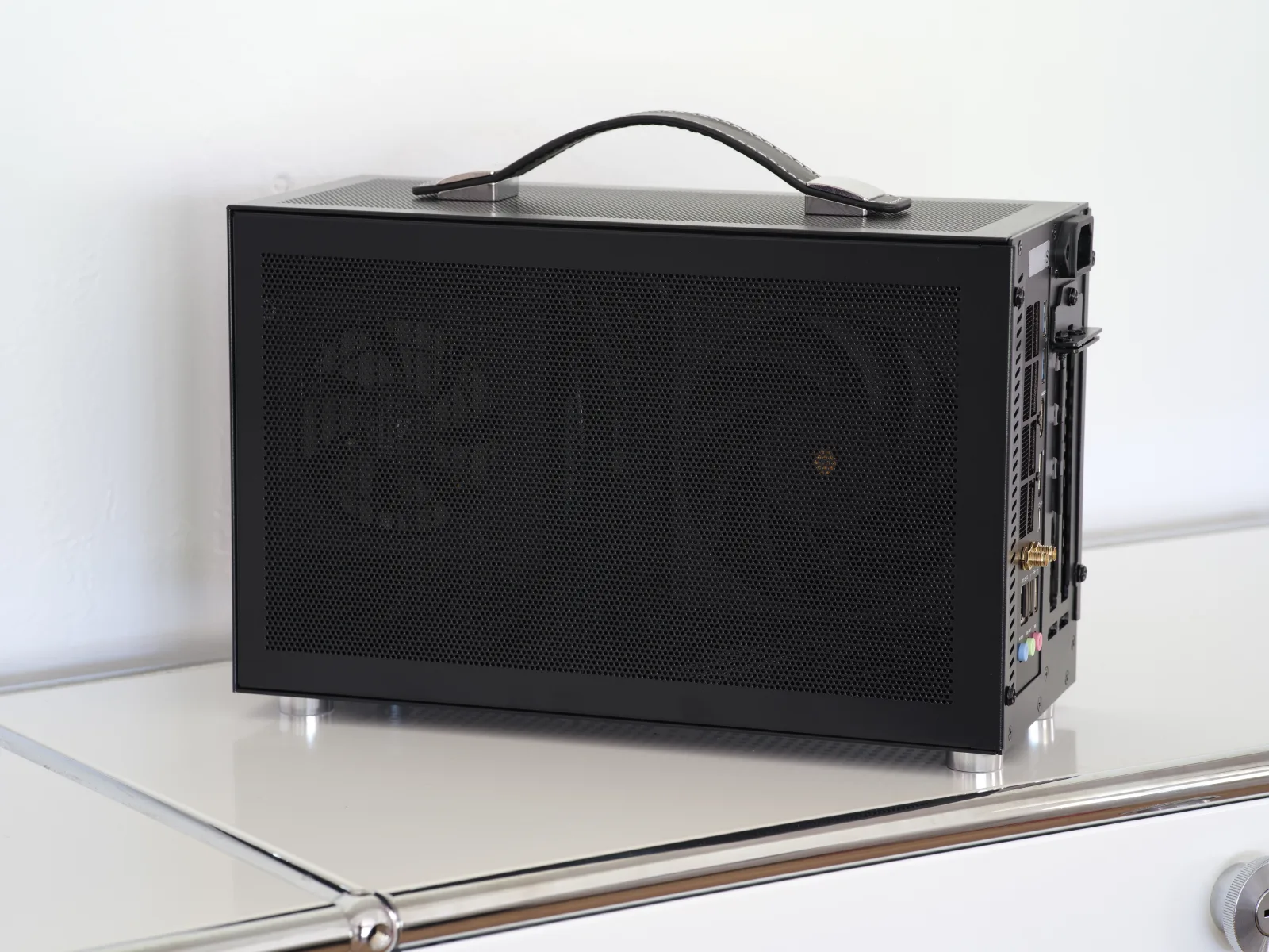 Compact small form factor (SFF) mini gaming PC next to its components